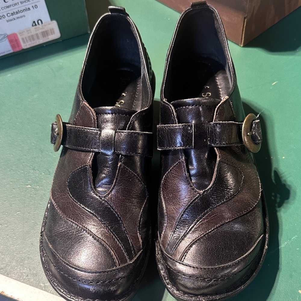 Black leather slip on great condition, black and brown in color, buckle on side